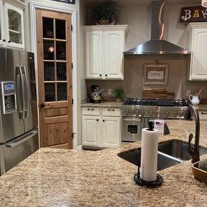 a kitchen with granite counter tops and stainless steel refrigerator freezer next to an oven