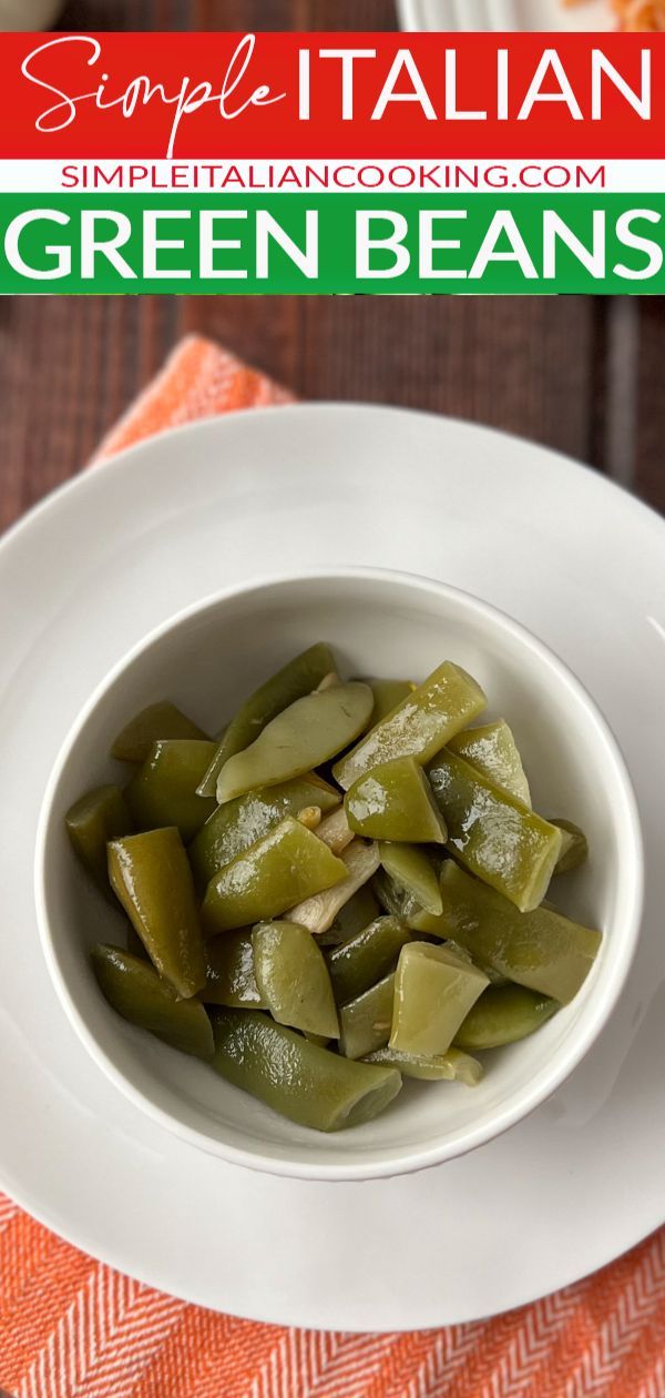 a white bowl filled with green beans on top of a table next to an orange towel