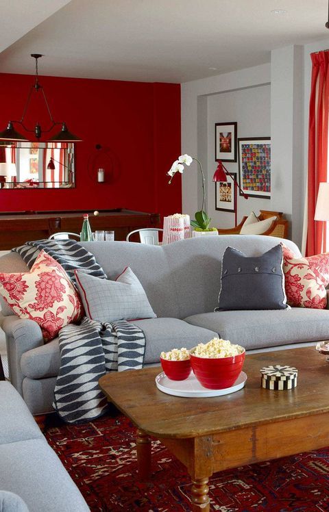 a living room filled with furniture and red walls