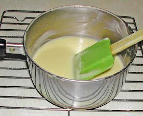 a metal pan filled with liquid on top of a stove