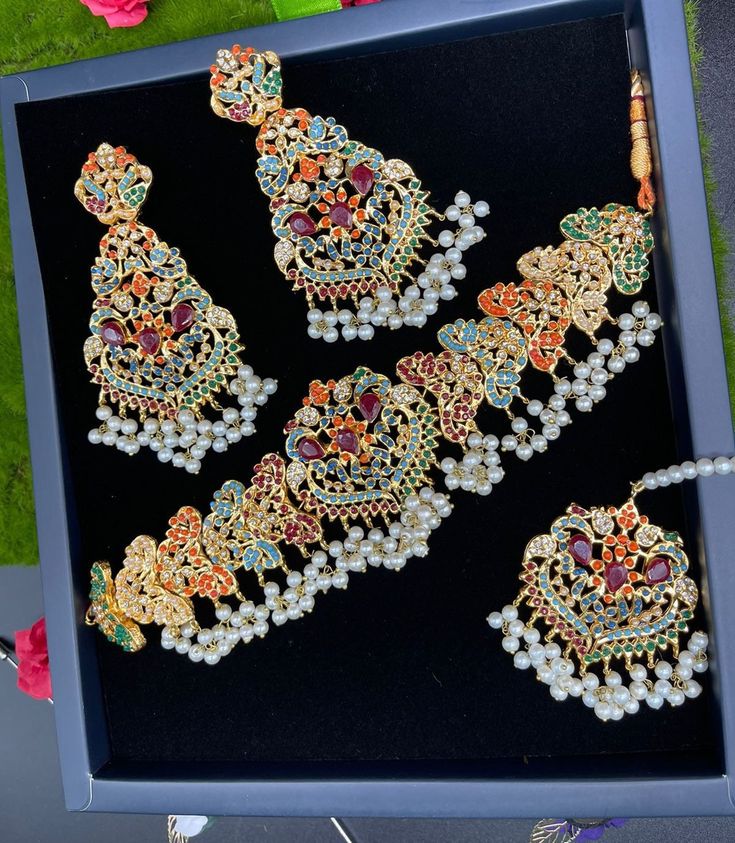 Pakistani made beautiful Navratna choker set is in style now... Grab it now it's a best deal ever. Multicolor Jewelry With Intricate Design For Party, Hand Set Bridal Choker Necklace For Celebration, Hand Set Bridal Choker For Celebration, Festive Choker Necklace For Weddings, Party Choker With Intricate Design, Hand-set Bridal Choker Necklace For Celebration, Festive Wedding Choker Necklaces, Festive Wedding Choker Necklace, Elegant Wedding Sets With Choker