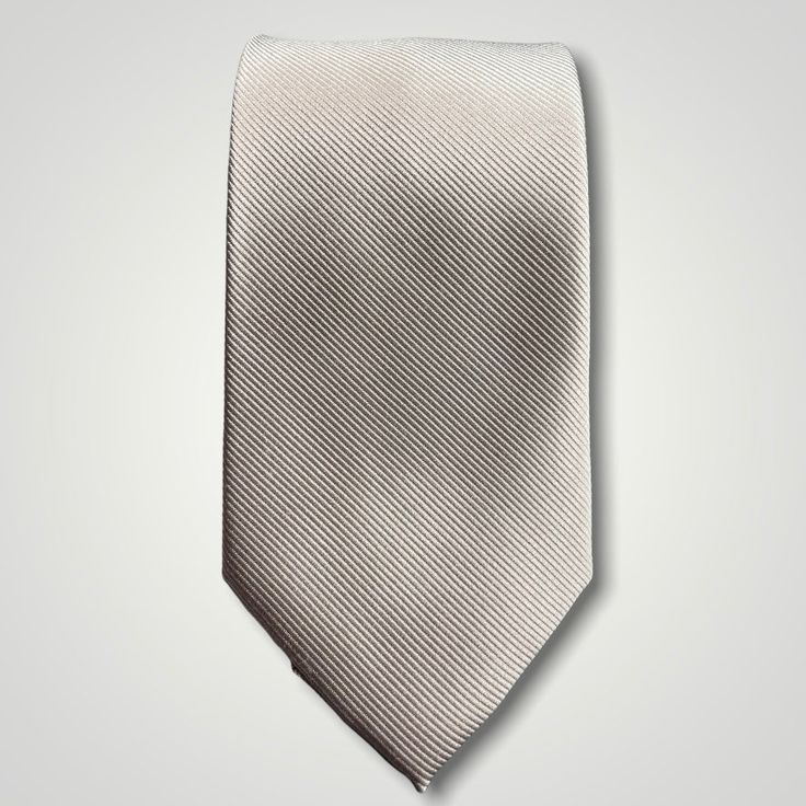 Solid ties are beautifully paired with the more busy of patters of bold stripes and heavy plaids. However, there is something so understated and elegant about a solid tie with a solid suit. Whether that be navy, charcoal or black a silver tie fits well with a white shirt and even a navy blazer with jeans. Silver necktie can also be used with formal wear. Classic Fitted Silver Suit And Tie Accessories, Classic Gray Suit And Tie Accessories For Formal Events, Classic Gray Suit And Tie Accessories For Formal Occasions, Classic Gray Suit And Tie Accessories, Silver Ties For Black Tie Events, Classic Gray Ties For Work, Classic Gray Ties For Workwear, Classic Gray Tie For Black Tie Events, Gray Standard Tie For Business