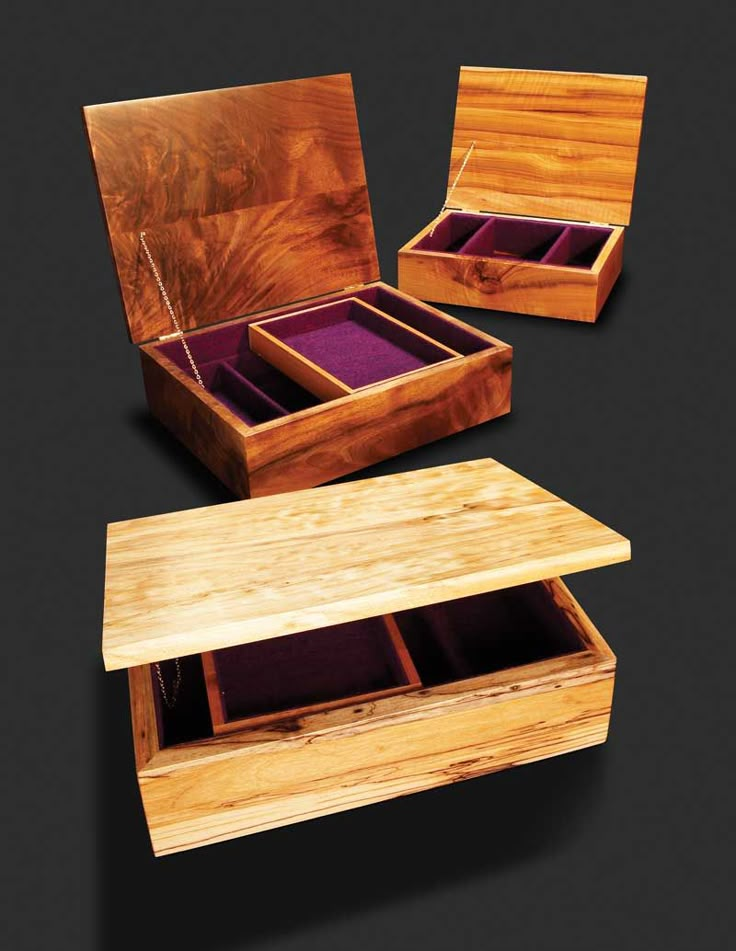 three wooden boxes with purple velvet inside and outside the lids, one containing two sets of jewelry