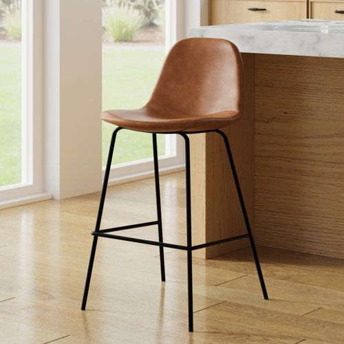 a brown bar stool sitting on top of a hard wood floor next to a counter