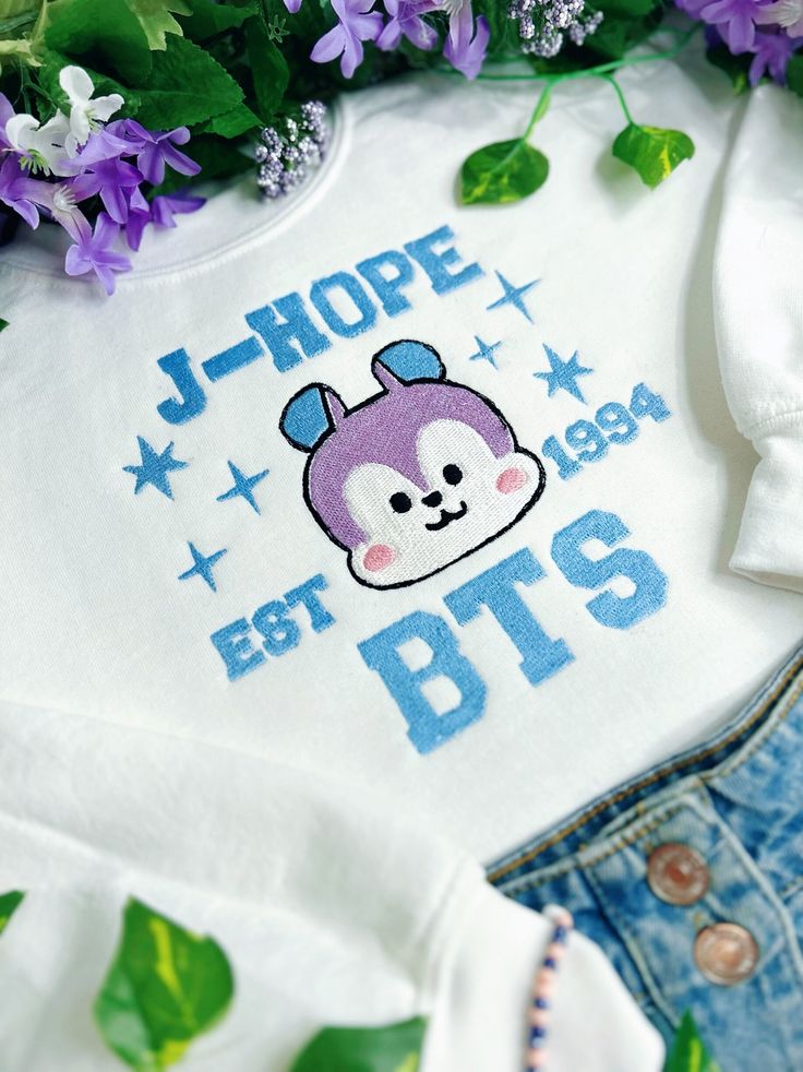 a t - shirt with the words hope and bt's on it next to purple flowers