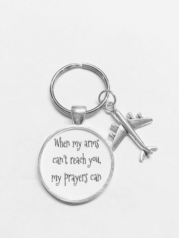 a keychain with an airplane on it that says, when my arms can't reach you, my prayer can