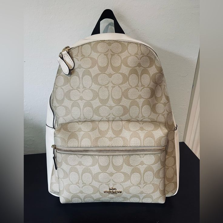 Beautiful Coach Signature Backpack- Used 1x! Practically Brand New!!! Signature Backpack With Smooth Cream Colored Leather Details. Inside Backpack Contains Zipper Pocket As Well As 2 Slip Pockets. Shoulder Straps Are Adjustable And Very Comfortable! Measurements Are As Follows: 10 3/4” (L) X 12 1/2” (H) X 4” (W) Colors: Im/Light Khaki/Chalk Does Not Come With A Dust Bag. Retails For: $428 (Last Picture Shows The Style/Size.) Coach Backpack Women, Designer Tote Backpack For Everyday Use, Designer Everyday Backpack Tote, Designer Everyday Tote Backpack, Luxury Beige Backpack With Adjustable Strap, Classic Beige Backpack With Detachable Strap, Designer Everyday Backpack With Removable Pouch, Classic Beige Rectangular Backpack, Classic Beige Backpack Bag