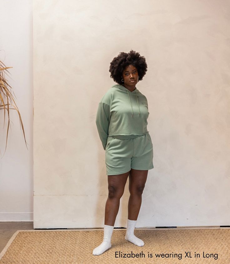 These cozy shorts include comfy cotton, a relaxed fit, and discreet pockets. Pair with the Sharell Cropped Sweat Hoodie for the perfectly chill "Sha" set. The Shavon Sweat Short is inspired by women who aspire to be everything they can for the ones they love. Color: Laurel Green Relaxed Fit Cotton Sweats For Relaxation, Cozy Relaxed Fit Pajama Shorts For Leisure, Cozy Relaxed Pajama Shorts For Leisure, Cozy Leisure Pajama Shorts, Relaxed Fit Organic Cotton Sweats For Loungewear, Cozy Relaxed Fit Pajama Shorts, Casual Sleepwear With Built-in Shorts For Relaxation, Green Cotton Shorts For Loungewear, Cotton Loungewear Hoodie