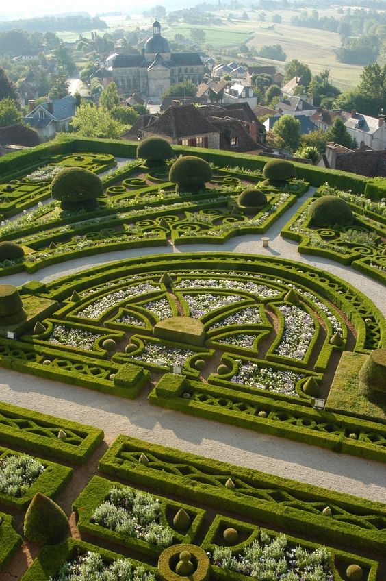 an aerial view of a garden with hedges