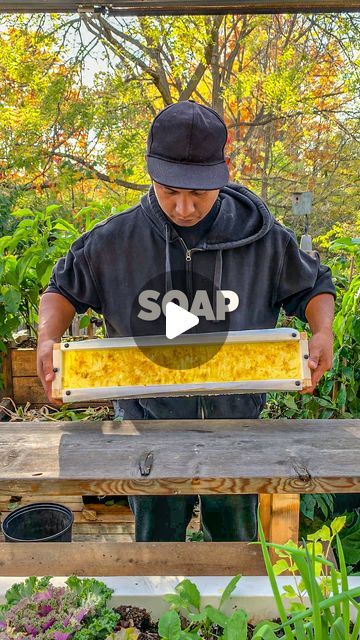 a man holding up a beehive with the words sap on it in front of him