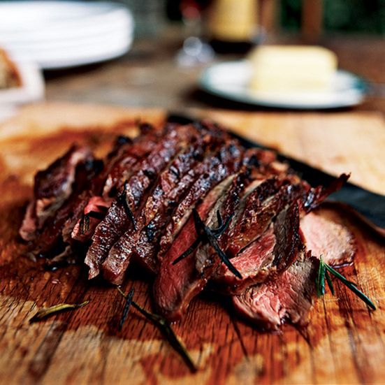 sliced up steak on a cutting board with knife