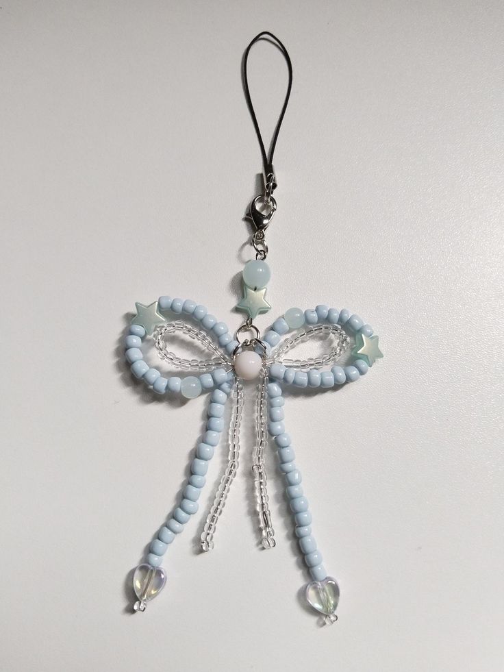 a blue and white beaded cross ornament