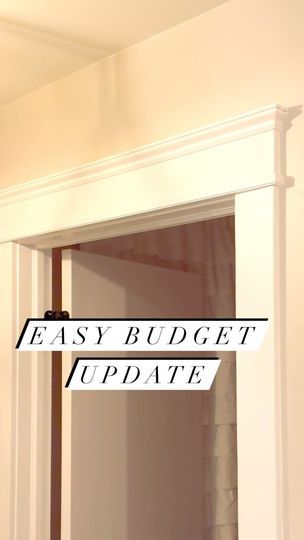 an easy budget update sign hanging on the wall above a mirror in a room with white walls