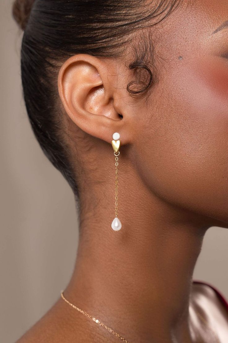 The Aimee Pearl Earrings are meticulously handcrafted using freshwater drop pearls paired with 14k gold-filled components, holding a unique and playful appeal.  Packaged in an elegant plastic-free reusable jewelry box, they make the perfect gift or special treat for oneself. 14k Gold-filled components Freshwater drop pearls Hypoallergenic, suitable for even the most sensitive skin Delivered in a 100% silk jewelry pouchette inside a gift box Sustainable magnetic closure jewelry box and customizable card   Please note, as we use only natural pearls, shape and size may vary slightly.  We offer a one year guarantee from the date of delivery. Lost an earring? Ask us how you can purchase a single earring. Gold Plated Teardrop Bridal Earrings, Gold Plated Teardrop Bridal Earrings For Gift, Yellow Gold Linear Earrings With Pearl Drop For Gift, Yellow Gold Drop Bridal Earrings For Gift, Yellow Gold Linear Earrings With Pearl Charm, Gift Yellow Gold Linear Earrings With Pearl Charm, Gift Teardrop 14k Gold Filled Pearl Earrings, Pearl Bridal Earrings In Yellow Gold As Gift, Gold Plated Pearl Drop Earrings As Gift