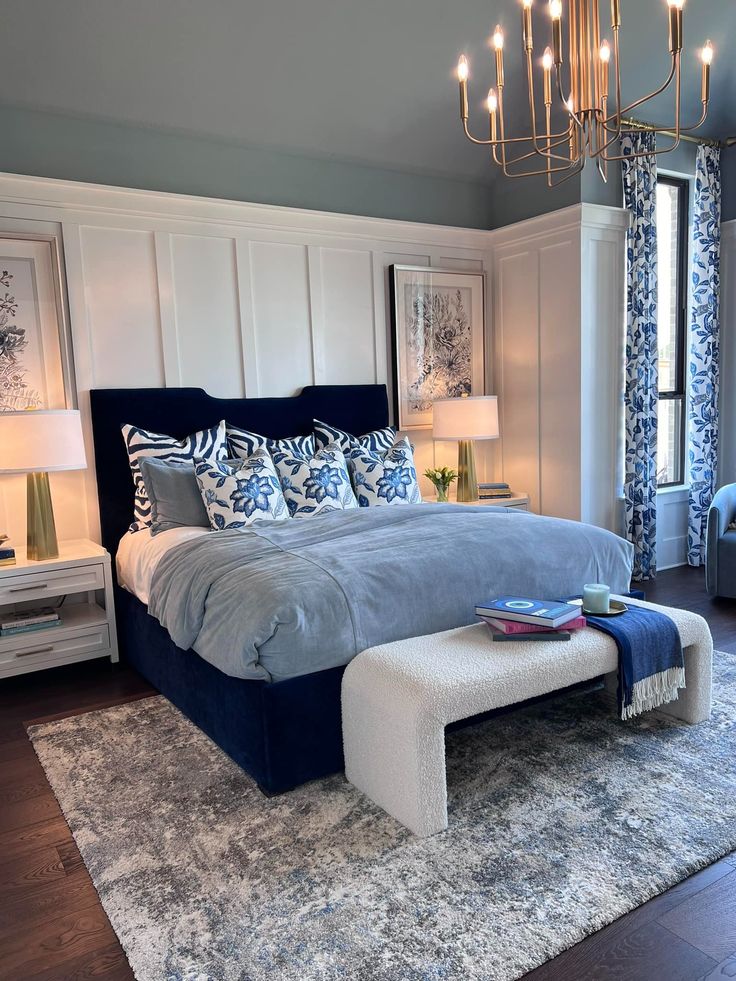 a large bed sitting in a bedroom next to a chandelier