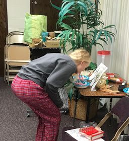 a woman bending over to look at a cake