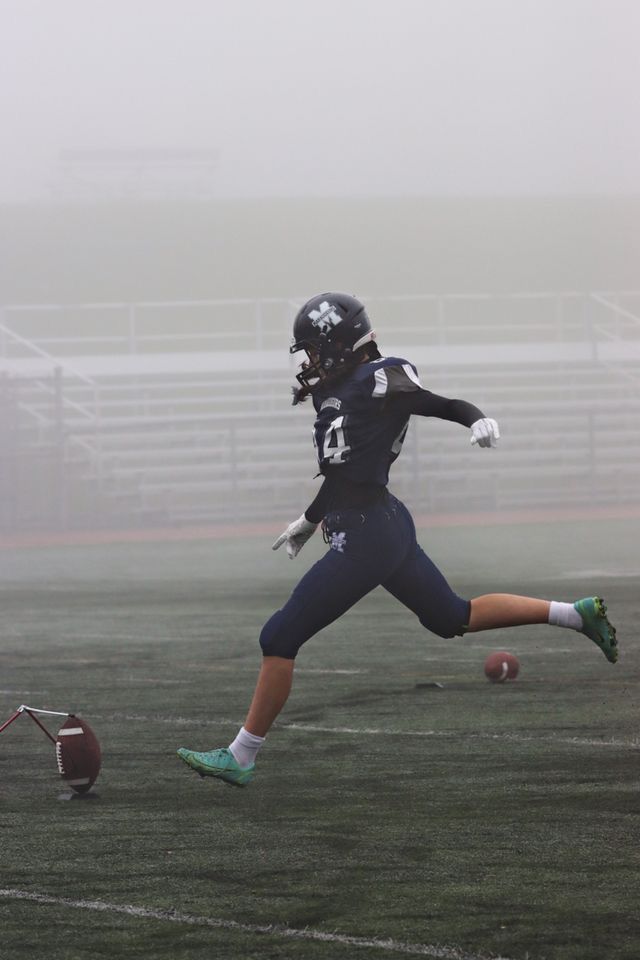 a football player is running with the ball