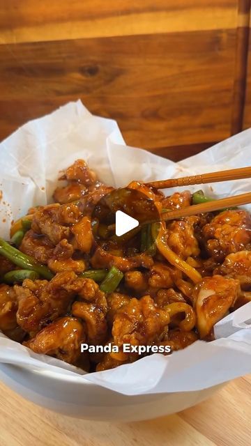 a bowl full of food with chopsticks in it