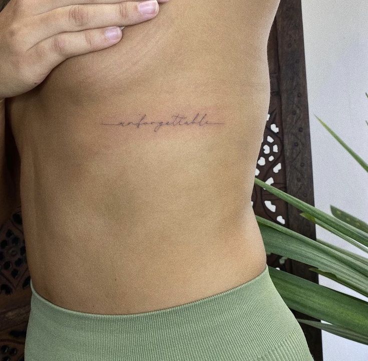 a woman's stomach with her hand on her hip and the word love spelled in cursive writing