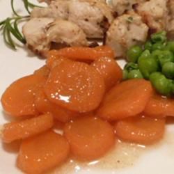 carrots, chicken and green peas on a white plate