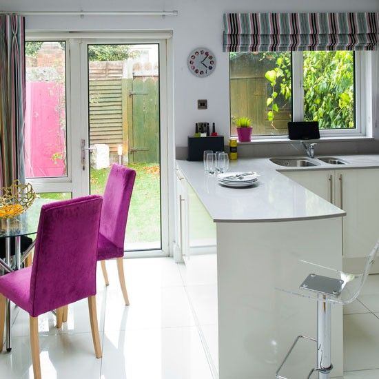 the kitchen is clean and ready to be used for dinner or party time, with purple chairs