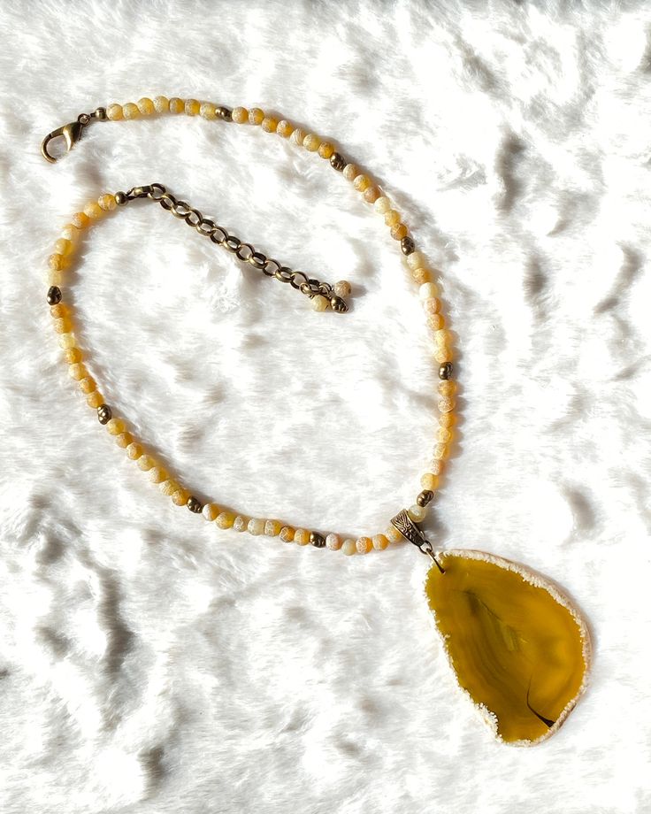 Genuine agate gemstone Metal is bronze plated alloy and brass beads 18" long, 3" chain, 21" total length We do our best to choose each stone carefully and purposefully for every piece.. However there might be slight differences in color size shape and clarity which makes each item unique and one of a kind.Each piece of jewelry will come in a colored drawstring bag for it’s protection and storage or to be ready to give as a gift.Our gemstone jewelry are all original designs by Lisa Beth and LDE A Yellow Agate, Brass Beads, Agate Slice, Agate Gemstone, Drawstring Bag, Gemstone Jewelry, Original Designs, Agate, Chain Necklace