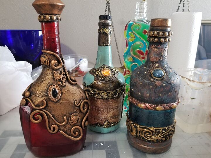 four different colored vases sitting on top of a table