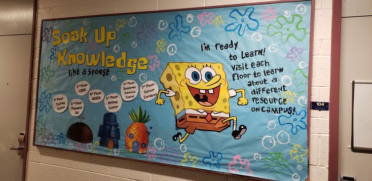 a bulletin board with spongebob sayings on it in a school hallway area