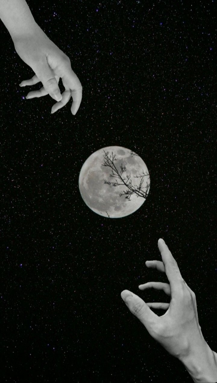 two hands reaching for the moon in the night sky