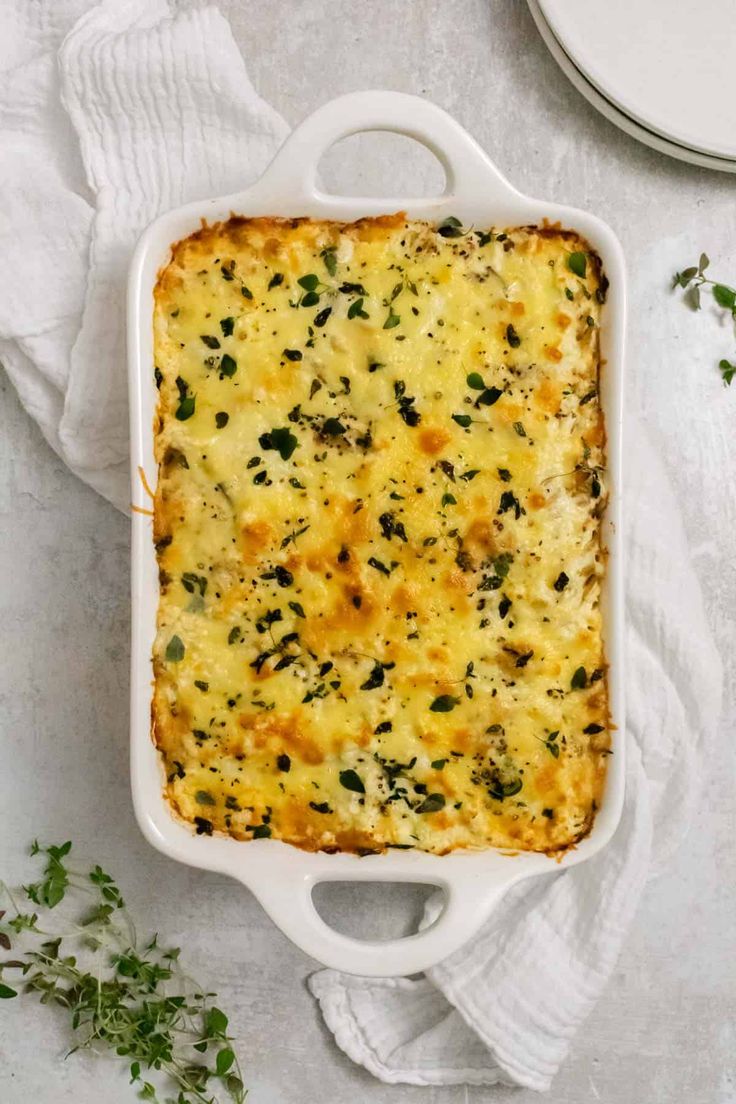 a casserole dish with cheese and herbs