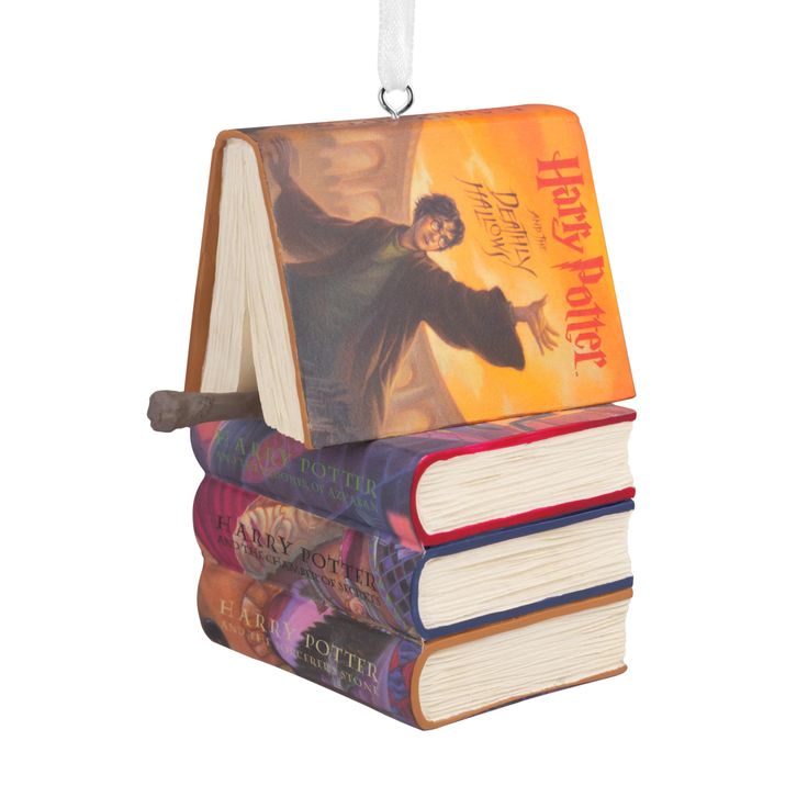 an ornament shaped like a book with harry potter on it and three stacked books