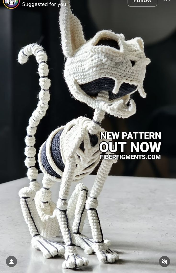 a crocheted cat sitting on top of a table