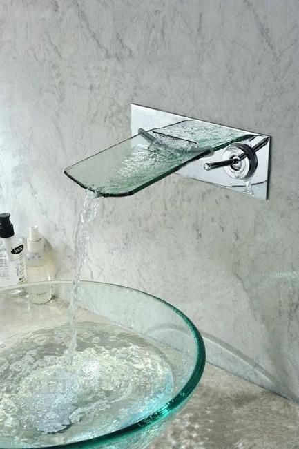 a glass sink with water running from it