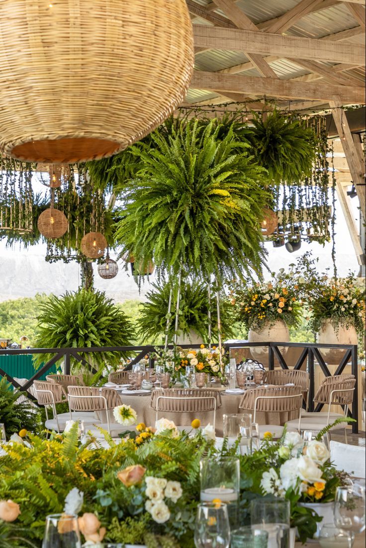 the tables are set with flowers and greenery