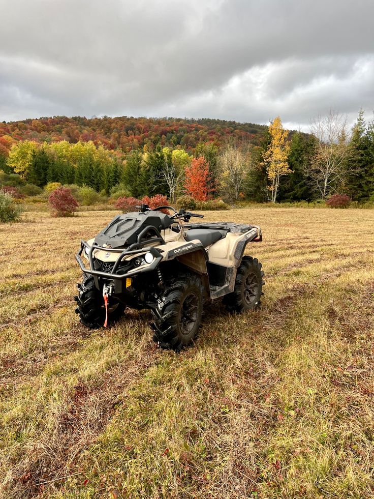 an atv is parked in the middle of a field