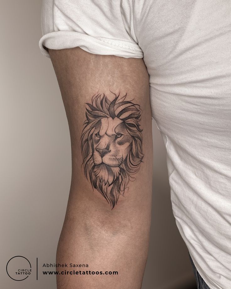 a man's arm with a lion tattoo on the left side of his body