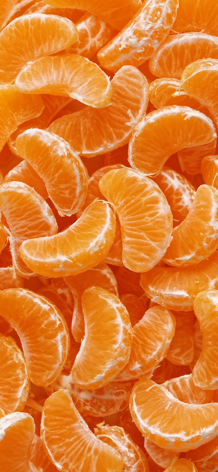 an image of peeled oranges piled on top of each other in close up view