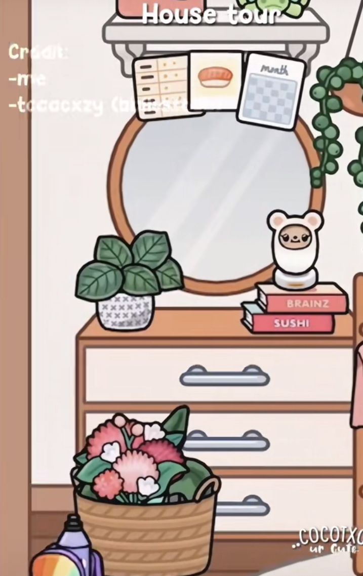 a room with a dresser, mirror and potted plant on it's side