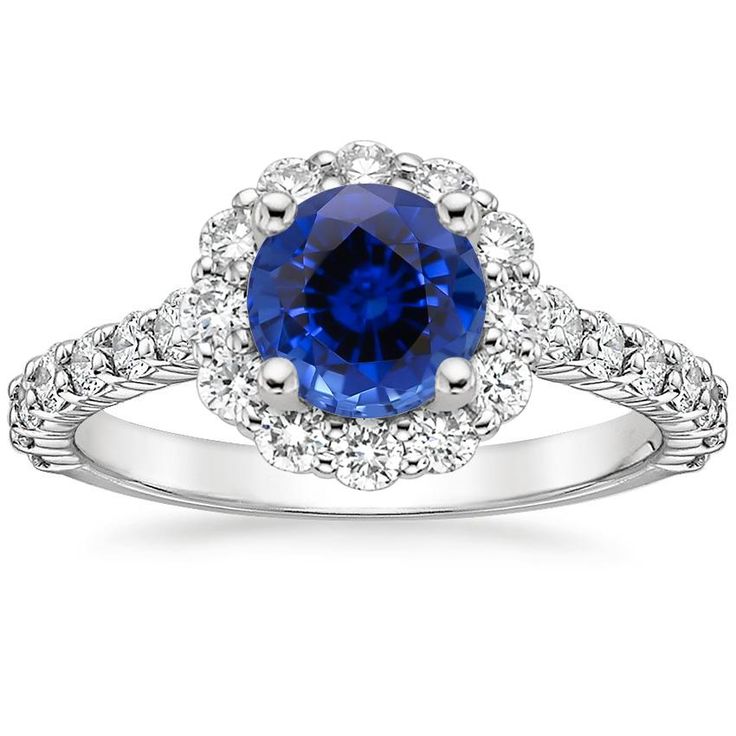 a blue sapphire and diamond ring with white diamonds on the band, set in 18k white gold