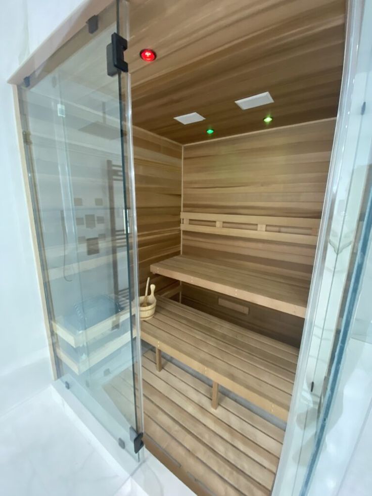 the inside of a sauna with glass doors