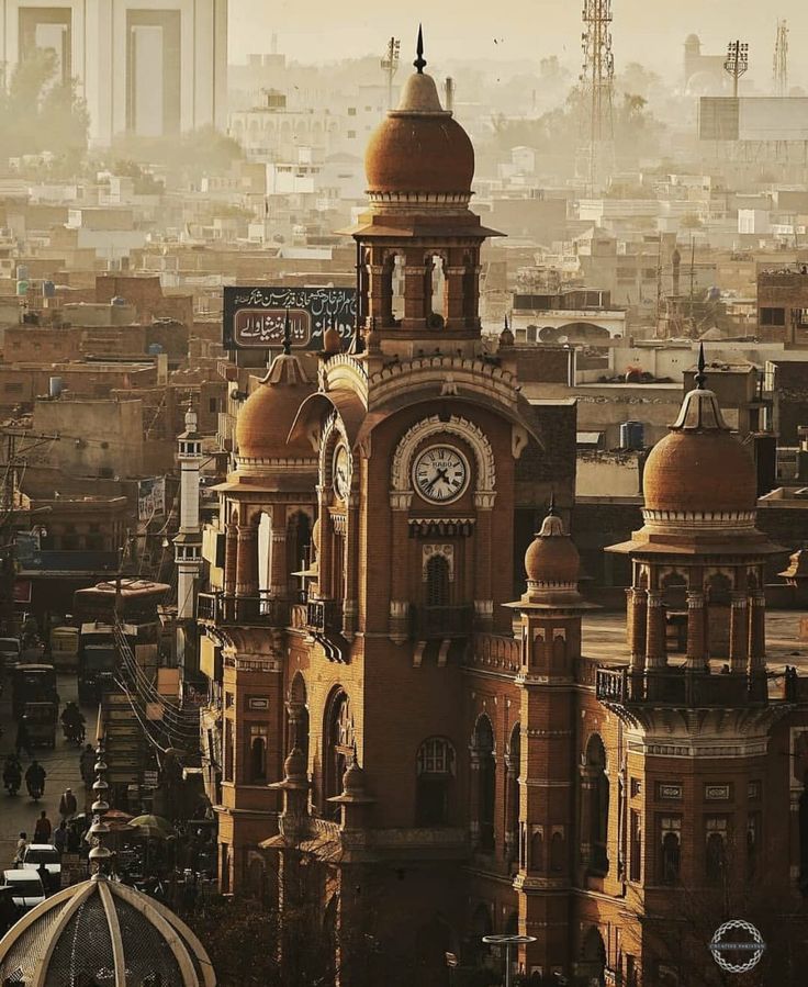 an old clock tower in the middle of a city