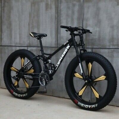 a bike parked next to a wall with yellow and black spokes on the front wheel