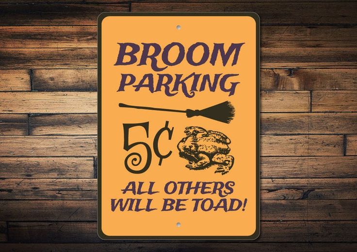 a yellow sign that says broom parking all others will be toad on the side of a wooden wall