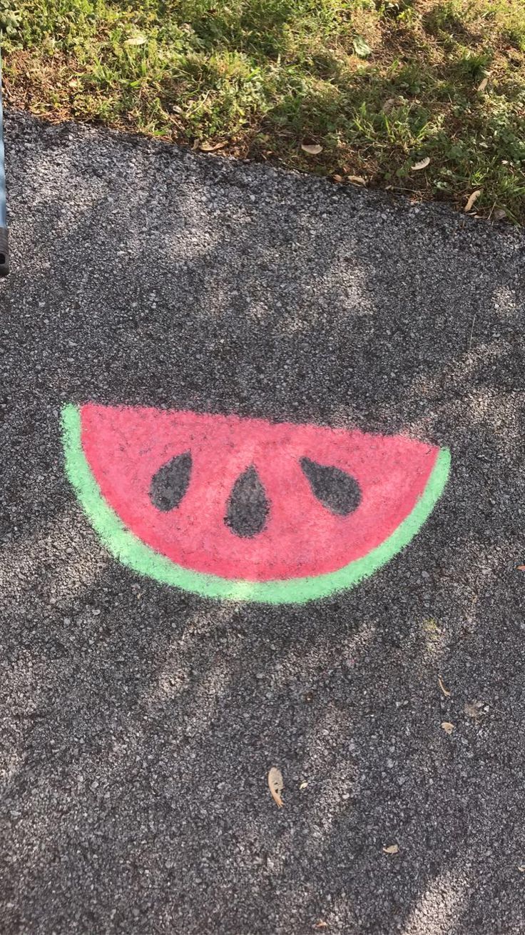 a slice of watermelon painted on the pavement