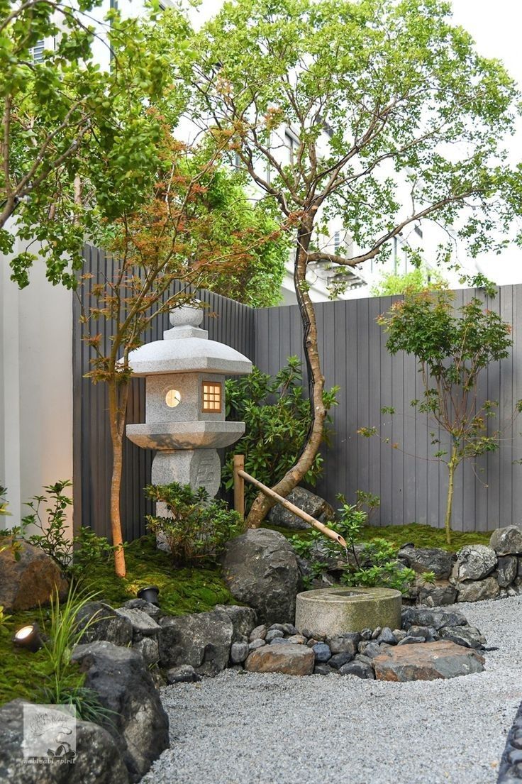 a small garden with rocks and trees