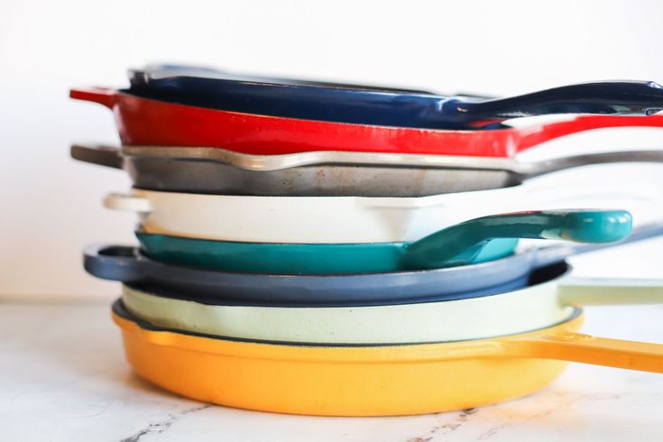 a stack of colorful bowls sitting on top of a white counter