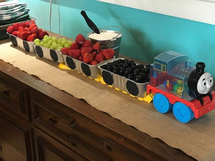 there is a train with fruit in it on the counter