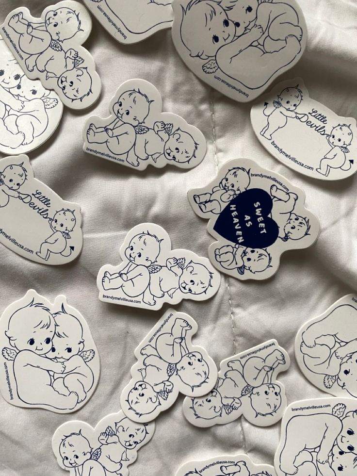 many stickers are laying on top of a sheet