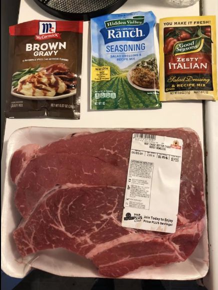 meat, seasoning, and other items are on the counter for preparation to cook