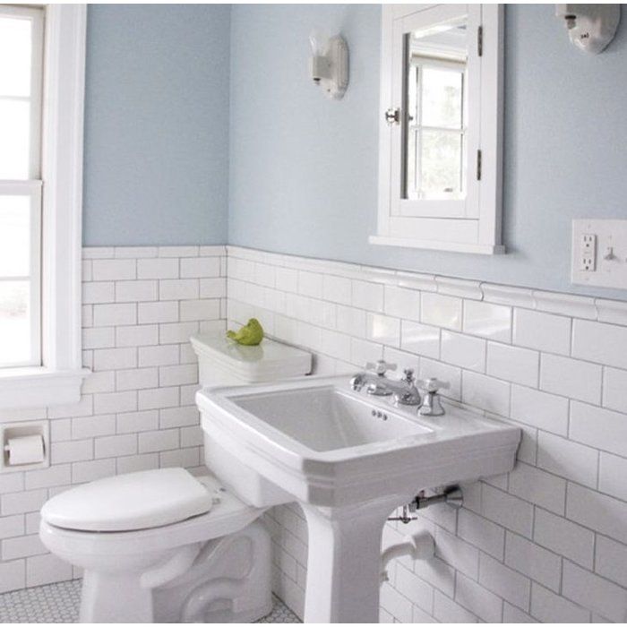 a bathroom with blue walls and white fixtures